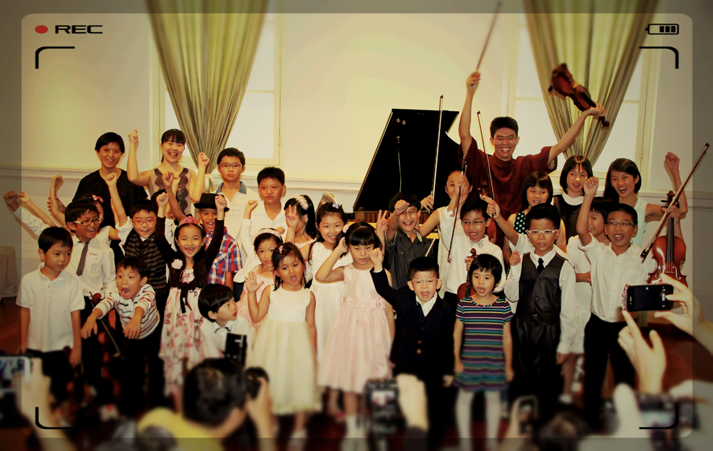 Music for the Young — students and teachers jumping in celebration
